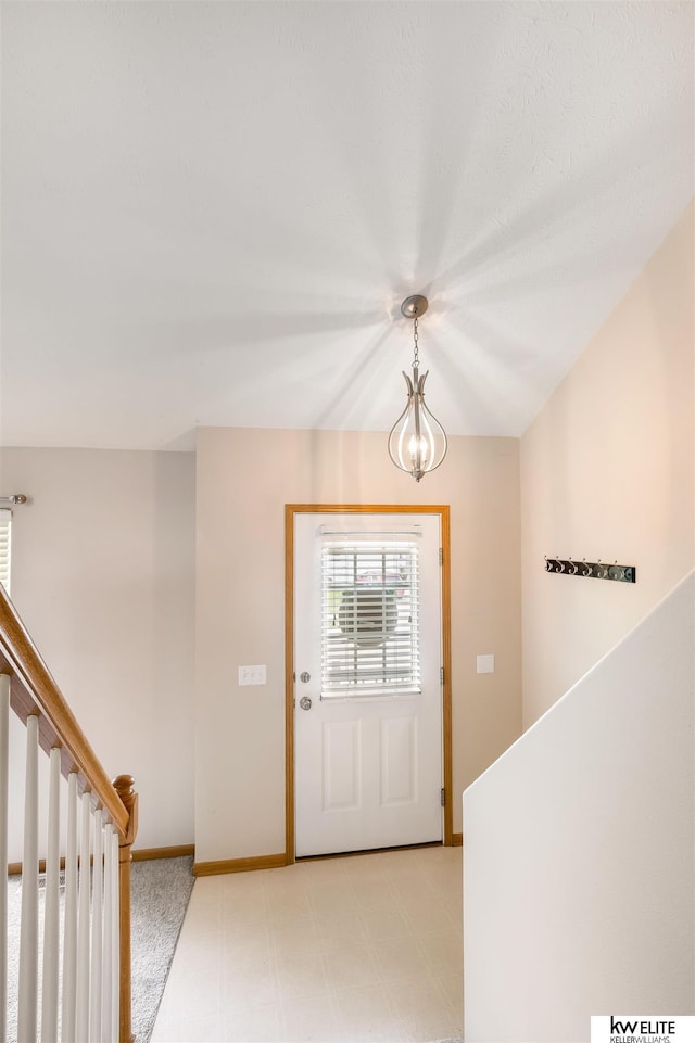 3015 N 144th Ter, Omaha, NE 68116 - foyer entrance with baseboards, stairway, and a chandelier