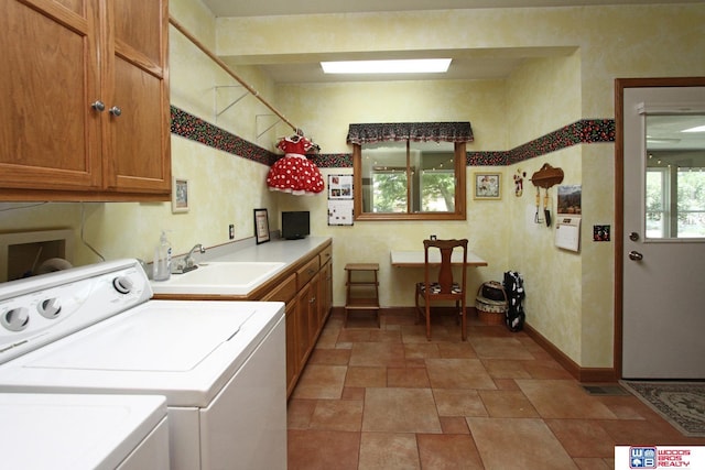 2600 Evergreen Cir, Beatrice, NE 68310 - laundry room featuring cabinet space, washing machine and dryer, baseboards, and stone finish floors