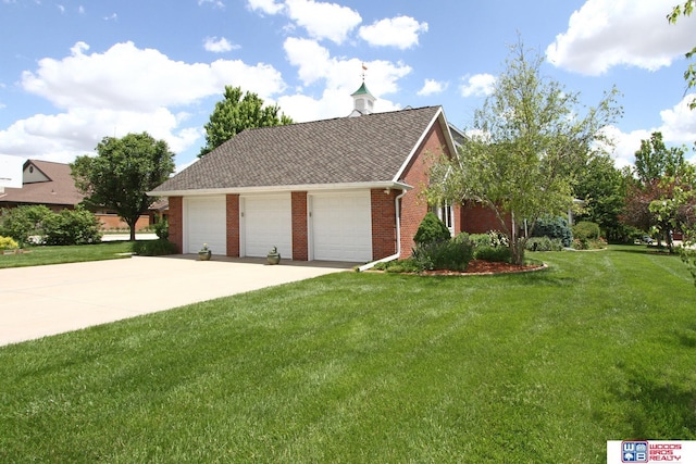 2600 Evergreen Cir, Beatrice, NE 68310 - view of front of house featuring a front yard, brick siding, a garage, and a shingled roof