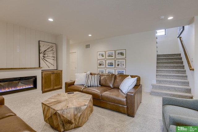 3639 S 218th Ave, Elkhorn, NE 68022 - living room with recessed lighting, light carpet, stairs, and a glass covered fireplace