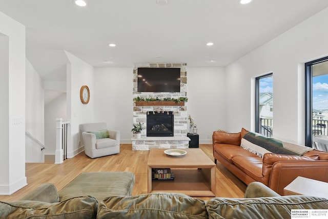 11065 N 171st St, Bennington, NE 68007 - living room featuring wood finished floors, recessed lighting, a stone fireplace, and baseboards