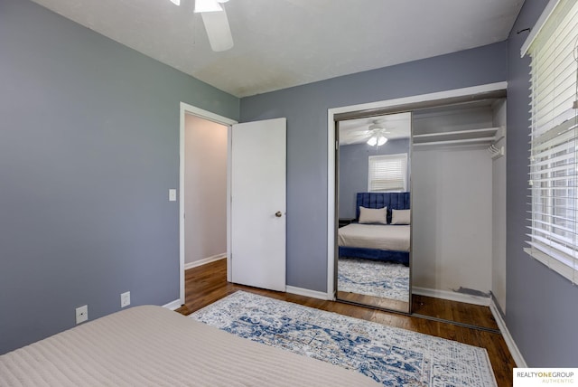 12180 Pedersen Dr, Omaha, NE 68144 - bedroom featuring wood finished floors, a closet, ceiling fan, and baseboards