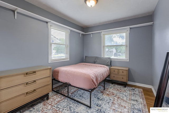12180 Pedersen Dr, Omaha, NE 68144 - bedroom featuring light wood-type flooring and baseboards