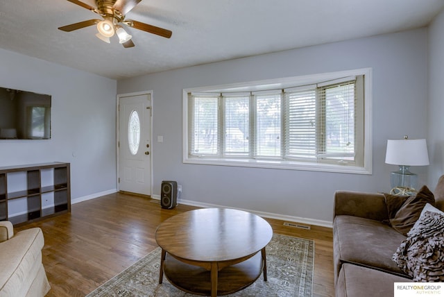 12180 Pedersen Dr, Omaha, NE 68144 - living area with healthy amount of natural light, ceiling fan, wood finished floors, and baseboards