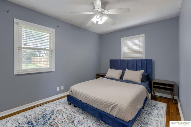 12180 Pedersen Dr, Omaha, NE 68144 - bedroom with wood finished floors, baseboards, and ceiling fan