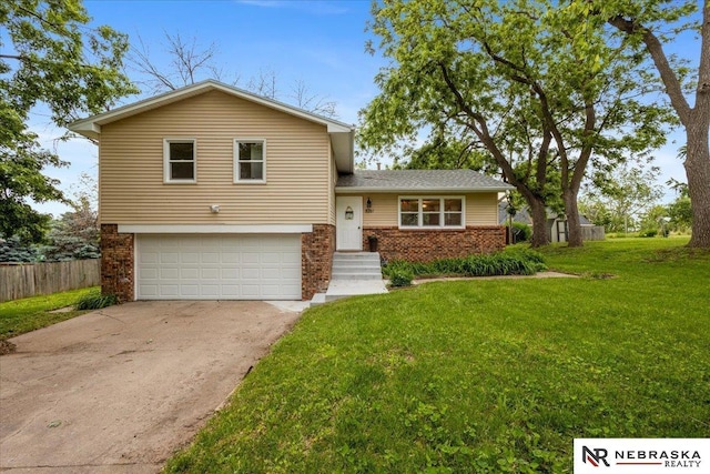 8261 Stephanie Ln, Bellevue, NE 68147 - tri-level home featuring brick siding, a garage, and driveway