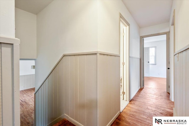 8261 Stephanie Ln, Bellevue, NE 68147 - corridor with light wood-style flooring, wainscoting, and an upstairs landing