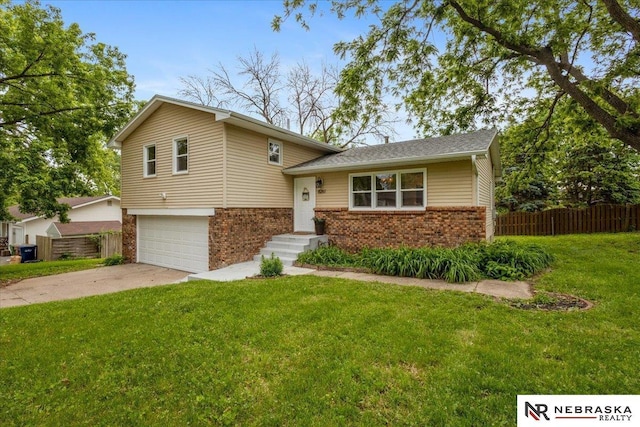 8261 Stephanie Ln, Bellevue, NE 68147 - split level home with brick siding, a garage, and driveway