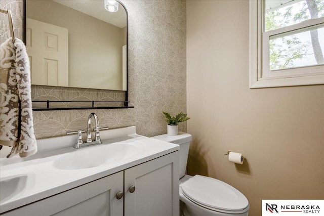 8261 Stephanie Ln, Bellevue, NE 68147 - bathroom featuring wallpapered walls, vanity, and toilet