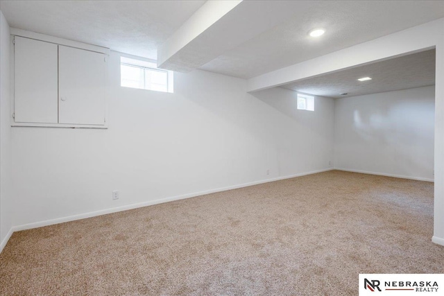 8261 Stephanie Ln, Bellevue, NE 68147 - below grade area featuring carpet flooring, baseboards, healthy amount of natural light, and recessed lighting