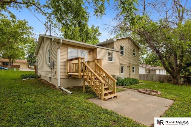 8261 Stephanie Ln, Bellevue, NE 68147 - rear view of house featuring an outdoor fire pit and a patio area
