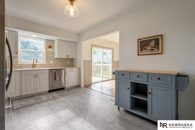 8261 Stephanie Ln, Bellevue, NE 68147 - kitchen featuring appliances with stainless steel finishes, a sink, light countertops, white cabinetry, and open shelves
