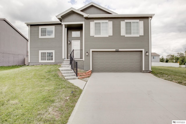 7707 N 88th St, Omaha, NE 68122 - split foyer home featuring a garage, a front lawn, and concrete driveway