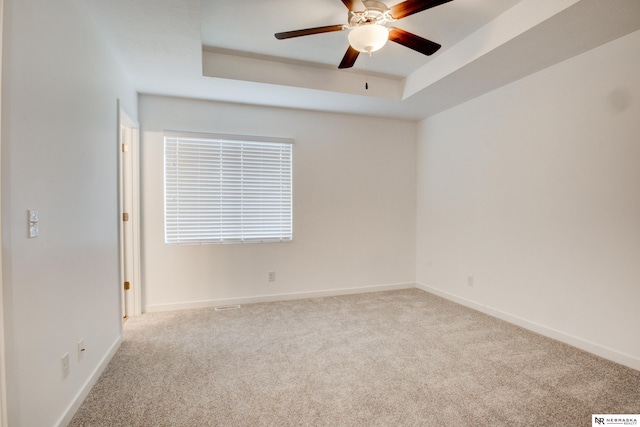 7707 N 88th St, Omaha, NE 68122 - carpeted empty room featuring ceiling fan, a tray ceiling, and baseboards