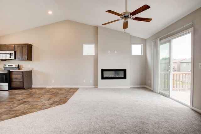 7707 N 88th St, Omaha, NE 68122 - unfurnished living room featuring carpet floors, ceiling fan, a glass covered fireplace, high vaulted ceiling, and baseboards