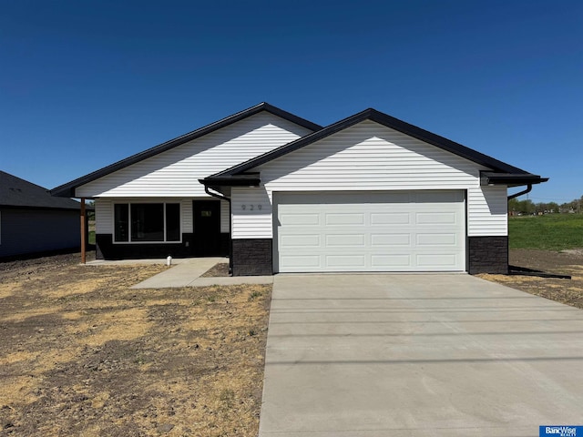 929 S Columbia Ave, Seward, NE 68434 - single story home featuring concrete driveway, a garage, and stone siding