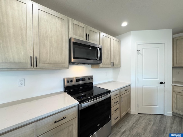 929 S Columbia Ave, Seward, NE 68434 - kitchen with appliances with stainless steel finishes, wood finished floors, light countertops, and recessed lighting