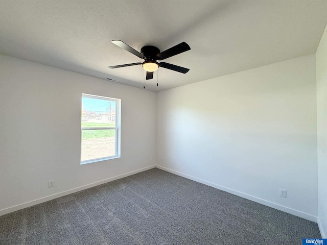 929 S Columbia Ave, Seward, NE 68434 - empty room featuring a ceiling fan, baseboards, and dark colored carpet