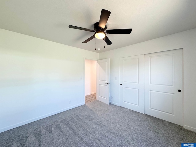 929 S Columbia Ave, Seward, NE 68434 - unfurnished bedroom featuring carpet, baseboards, a closet, and ceiling fan