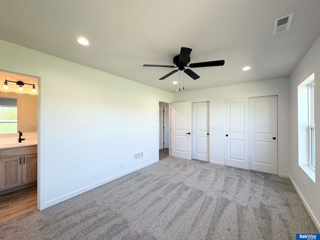 929 S Columbia Ave, Seward, NE 68434 - unfurnished bedroom featuring carpet flooring, multiple closets, recessed lighting, and baseboards