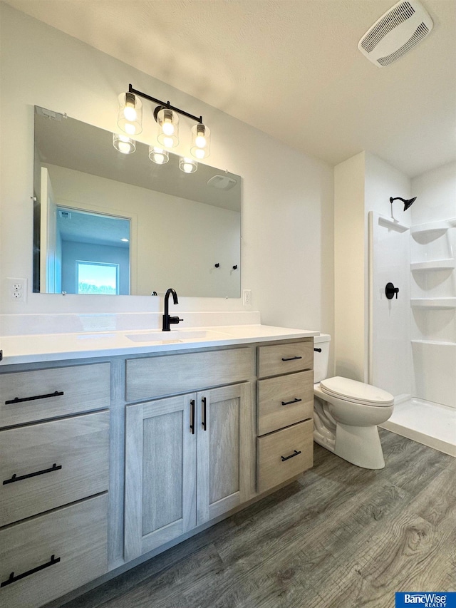 929 S Columbia Ave, Seward, NE 68434 - full bathroom featuring wood finished floors, a shower, vanity, and toilet