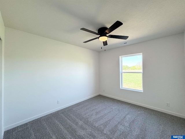 929 S Columbia Ave, Seward, NE 68434 - spare room featuring baseboards, dark colored carpet, and a ceiling fan