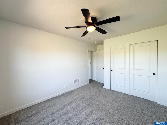929 S Columbia Ave, Seward, NE 68434 - unfurnished bedroom with baseboards, carpet flooring, a closet, and ceiling fan