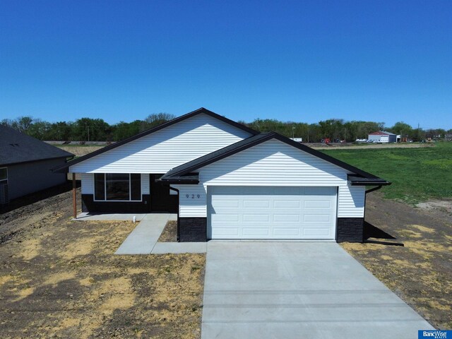 929 S Columbia Ave, Seward, NE 68434 - single story home with stone siding, a garage, and concrete driveway