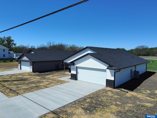 929 S Columbia Ave, Seward, NE 68434 - ranch-style house with concrete driveway, a shingled roof, and an attached garage