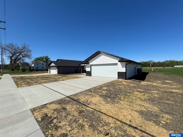 929 S Columbia Ave, Seward, NE 68434 - view of side of home with driveway and stone siding