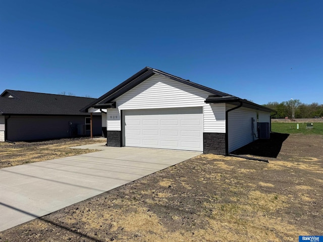 929 S Columbia Ave, Seward, NE 68434 - view of front of home with concrete driveway, cooling unit, and an attached garage