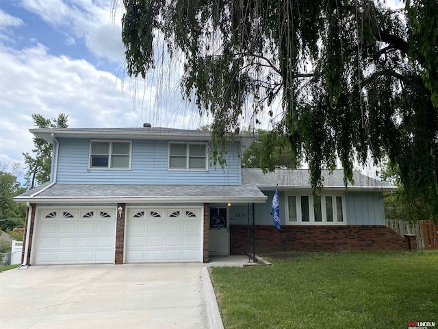 1501 Mildred Ave, Bellevue, NE 68005 - split level home featuring driveway, a garage, and brick siding
