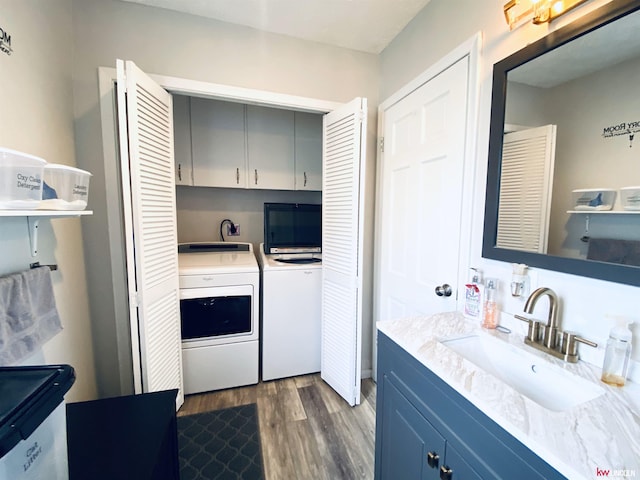 1501 Mildred Ave, Bellevue, NE 68005 - laundry area featuring washing machine and dryer, cabinet space, and dark wood-type flooring