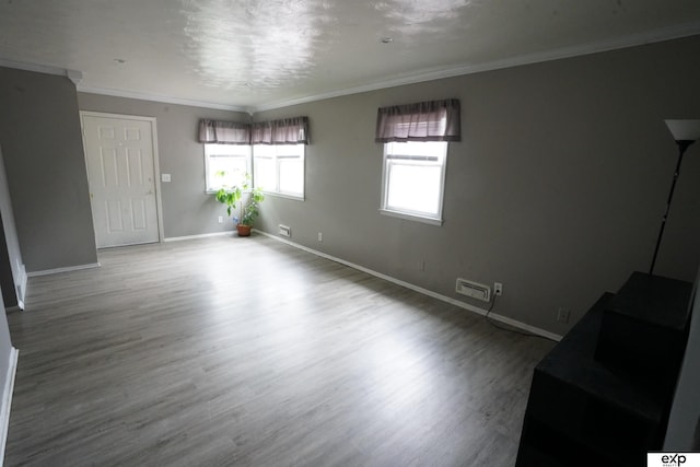 5433 N 45th Ave, Omaha, NE 68104 - empty room featuring wood finished floors, baseboards, and crown molding