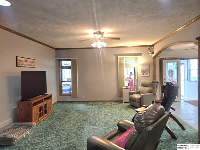 2205 Hidden Canyon Rd, Plattsmouth, NE 68048 - living room with crown molding, ceiling fan, arched walkways, and a textured ceiling