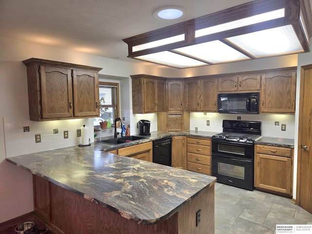 2205 Hidden Canyon Rd, Plattsmouth, NE 68048 - kitchen with black appliances, a sink, a peninsula, tasteful backsplash, and dark countertops