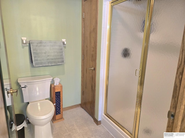 2205 Hidden Canyon Rd, Plattsmouth, NE 68048 - bathroom featuring toilet, baseboards, and a shower stall