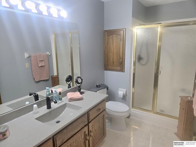 2205 Hidden Canyon Rd, Plattsmouth, NE 68048 - bathroom featuring toilet, a stall shower, and vanity