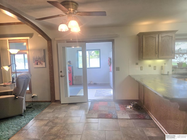 2205 Hidden Canyon Rd, Plattsmouth, NE 68048 - doorway to outside featuring ceiling fan, baseboards, and stone finish floors
