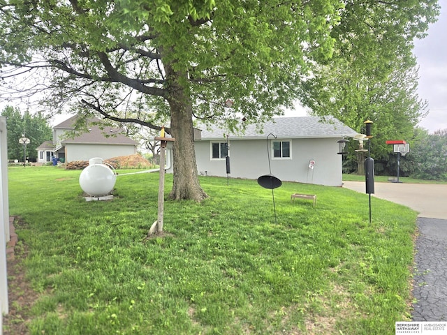 2205 Hidden Canyon Rd, Plattsmouth, NE 68048 - ranch-style home with stucco siding, a front yard, and a shingled roof