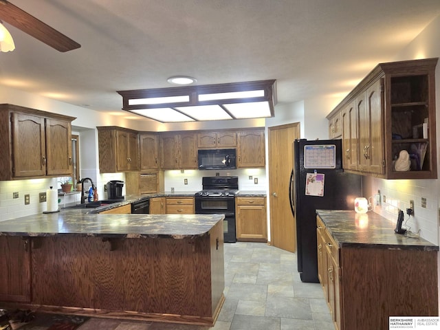 2205 Hidden Canyon Rd, Plattsmouth, NE 68048 - kitchen with black appliances, a peninsula, stone finish floors, tasteful backsplash, and a kitchen bar