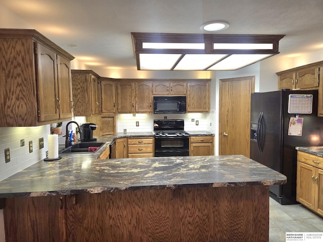 2205 Hidden Canyon Rd, Plattsmouth, NE 68048 - kitchen with black appliances, a sink, dark countertops, a peninsula, and tasteful backsplash