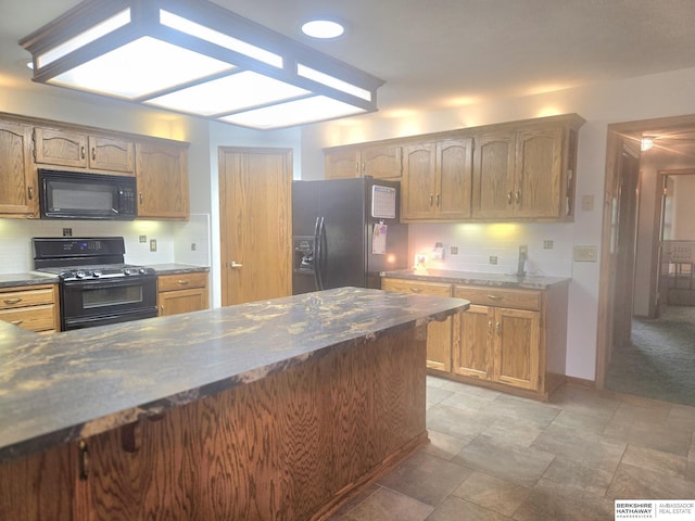 2205 Hidden Canyon Rd, Plattsmouth, NE 68048 - kitchen with black appliances, tasteful backsplash, stone finish floors, and baseboards
