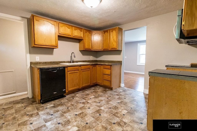 4518 Redick Ave, Omaha, NE 68152 - kitchen featuring black dishwasher, a sink, baseboards, a textured ceiling, and dark countertops