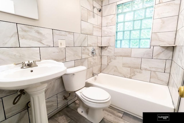 4518 Redick Ave, Omaha, NE 68152 - full bathroom featuring tile walls, toilet, and bathtub / shower combination