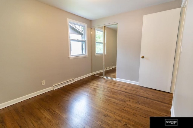 4518 Redick Ave, Omaha, NE 68152 - unfurnished bedroom featuring a closet, baseboards, and wood finished floors