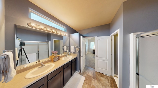 1609 N 208th St, Elkhorn, NE 68022 - bathroom with double vanity, a shower with door, baseboards, and vaulted ceiling