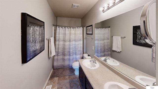 1609 N 208th St, Elkhorn, NE 68022 - bathroom featuring double vanity, toilet, baseboards, and stone finish floors