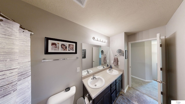 1609 N 208th St, Elkhorn, NE 68022 - full bath featuring toilet, double vanity, a textured ceiling, and baseboards
