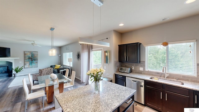 1609 N 208th St, Elkhorn, NE 68022 - kitchen featuring dishwasher, open floor plan, a sink, light wood-style floors, and recessed lighting